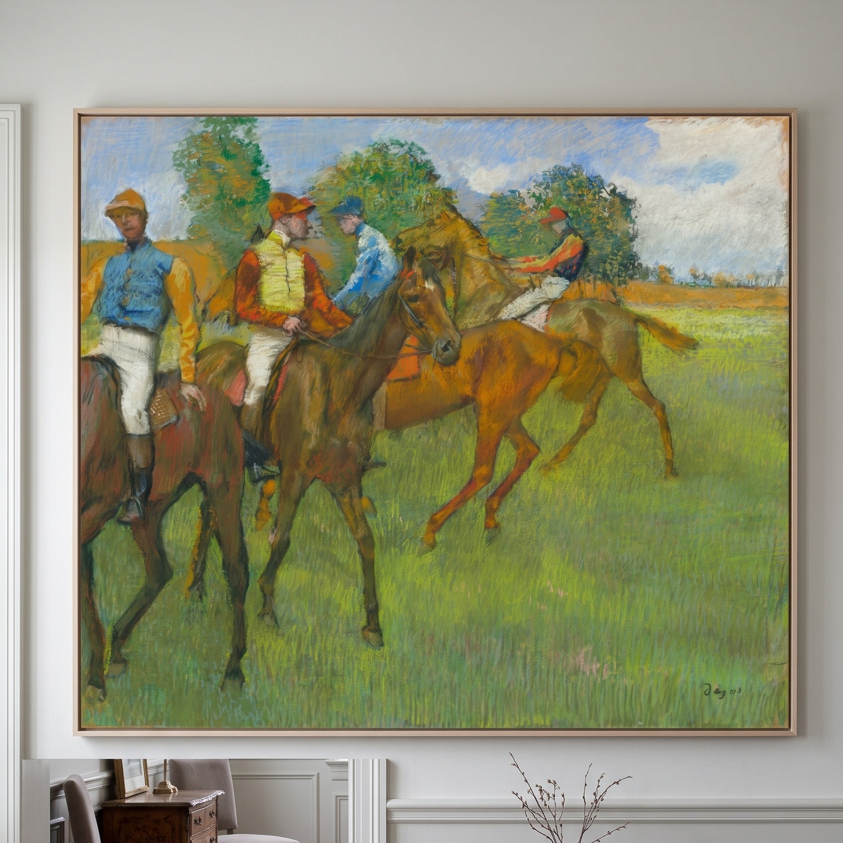 Before the Race by Edgar Degas — large green and brown Impressionist canvas art on a hallway wall